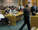 Photo of 2 little girls standing at podium in courtroom