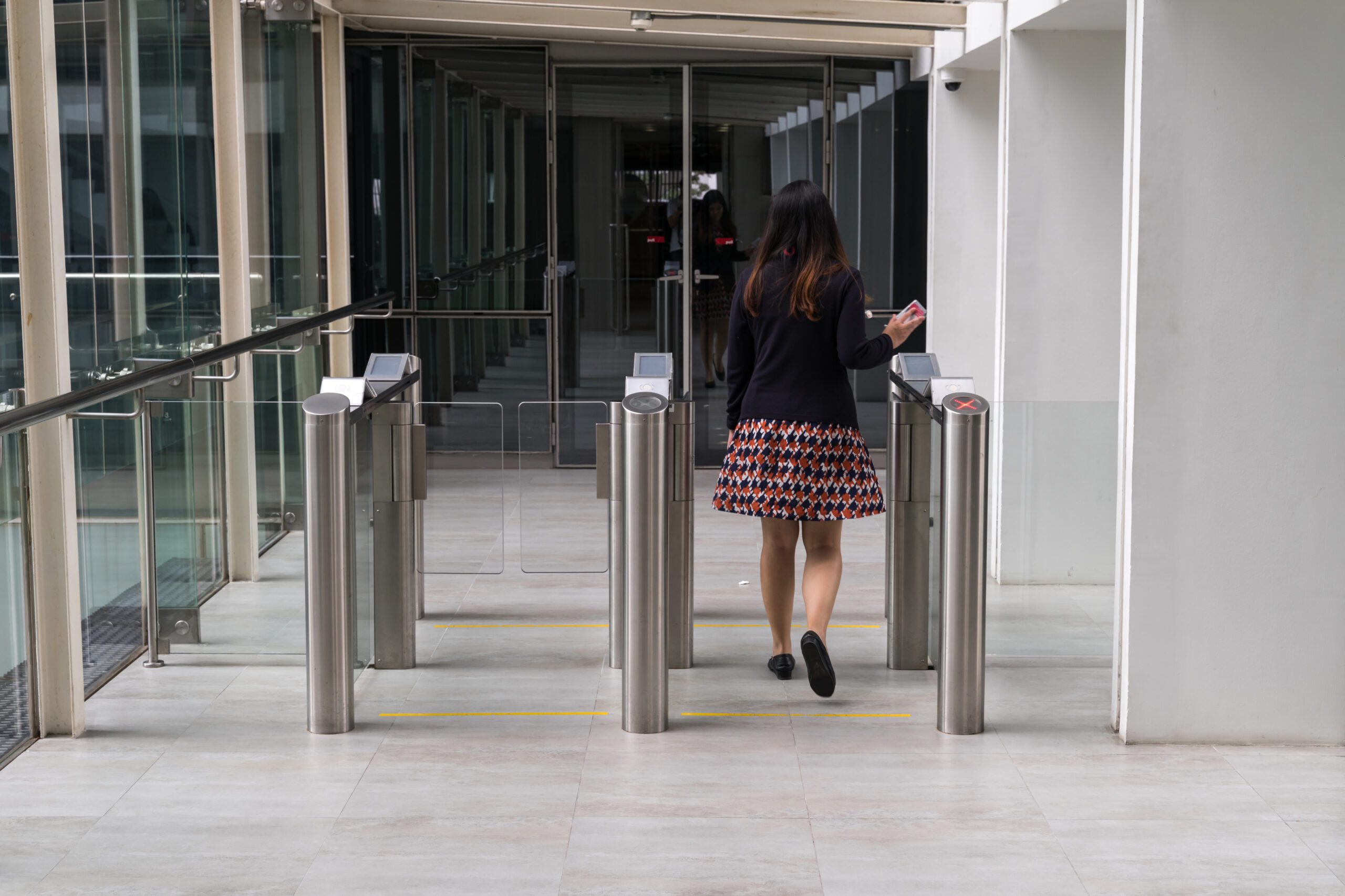 Attorney entering a courthouse security checkpoint using an identification badge.
