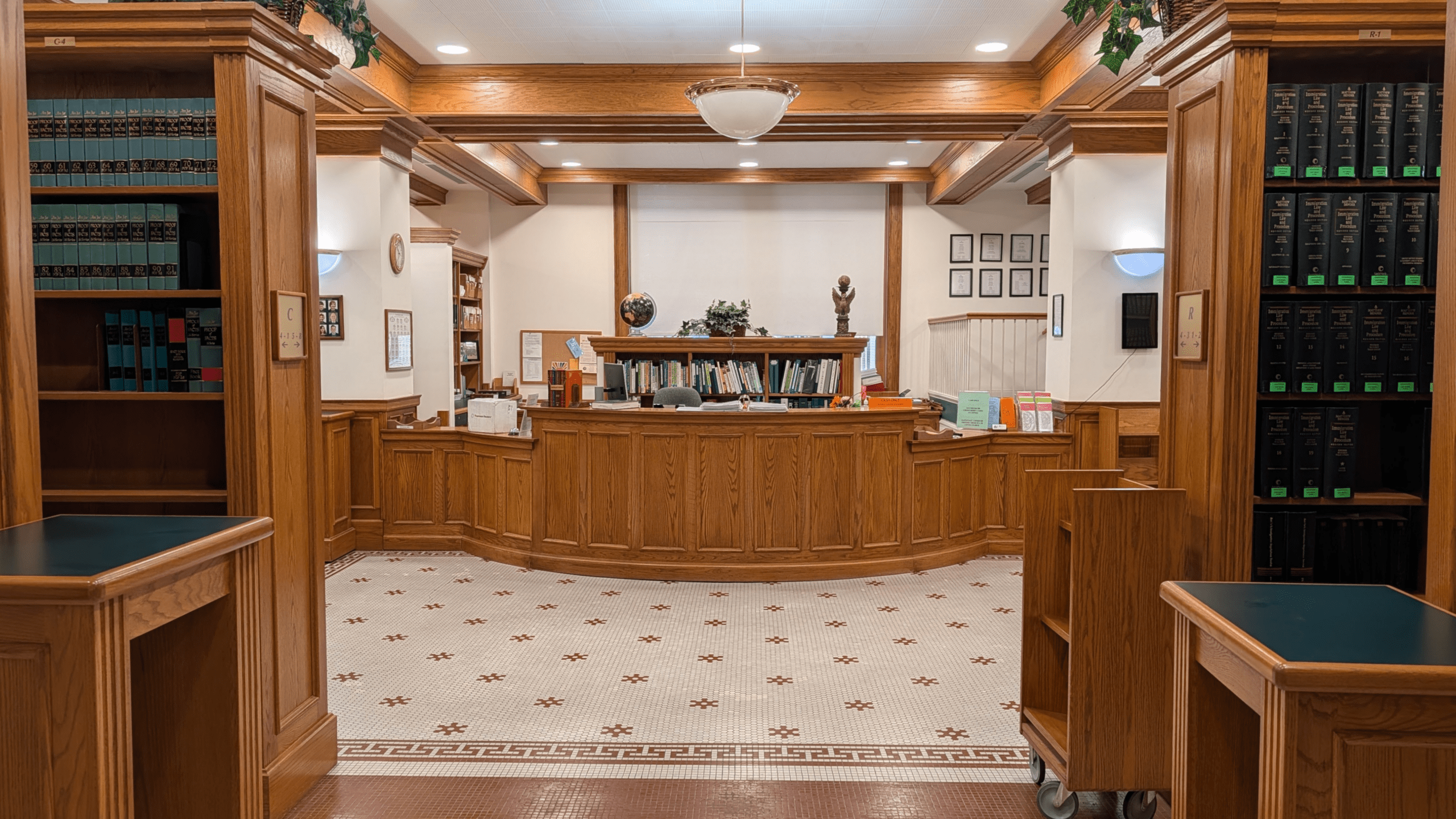 Law library interior with reception desk and bookshelves.